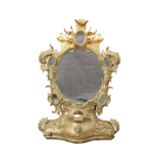 A ROCOCO REVIVAL CARVED AND GILDED MIRROR