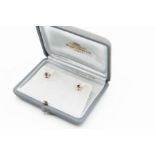 A PAIR OF RUBY AND DIAMOND STUD EARRINGS BY MAPPIN AND WEBB