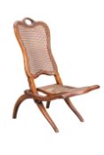 A VICTORIAN MAHOGANY AND CANEWORK FOLDING CAMPAIGN CHAIR