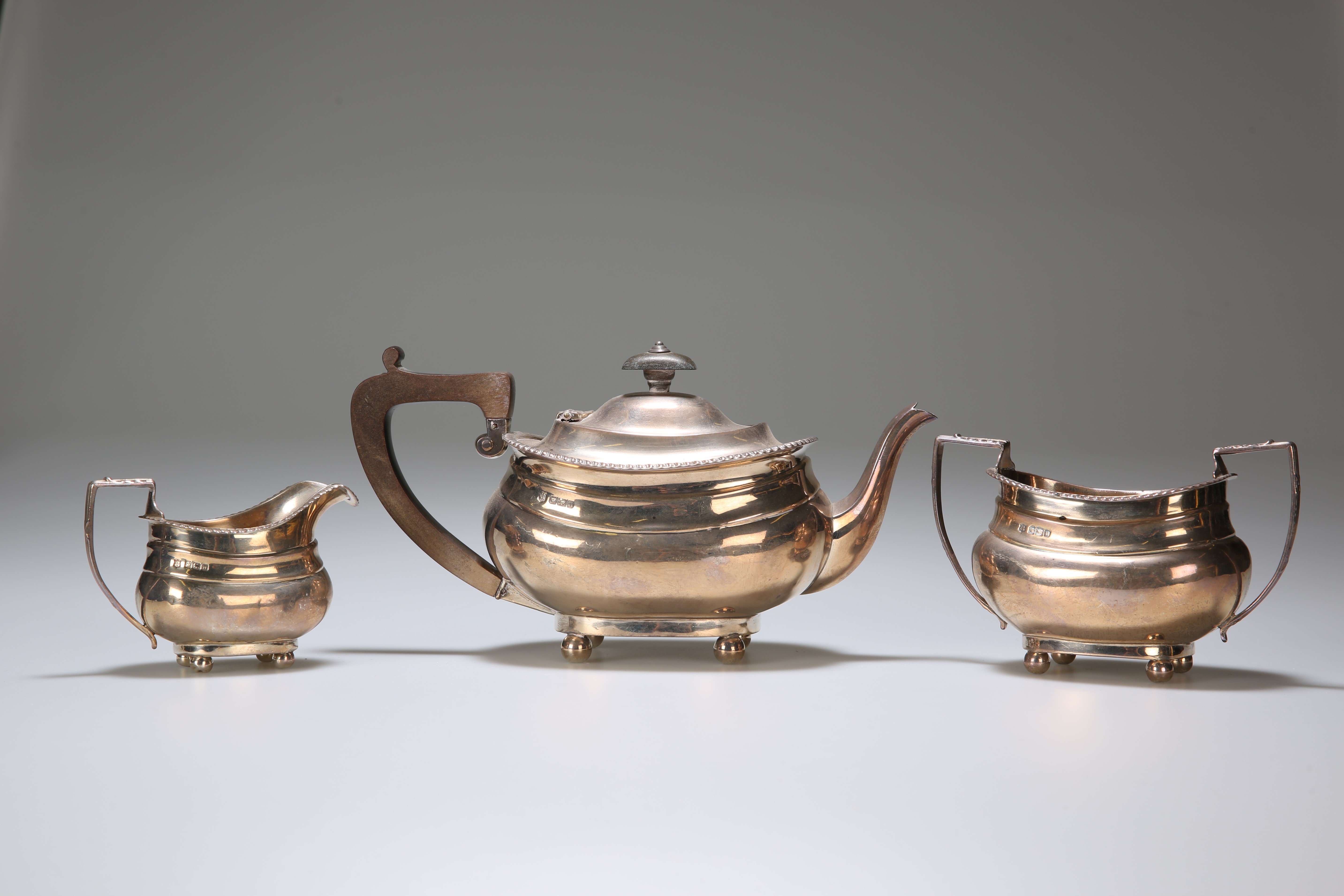 AN EDWARDIAN SILVER THREE-PIECE TEA SERVICE