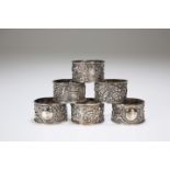 A SET OF SIX CHINESE EXPORT WHITE METAL NAPKIN RINGS, c.1900