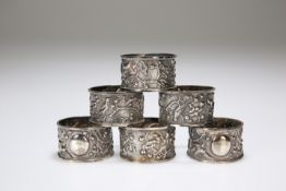 A SET OF SIX CHINESE EXPORT WHITE METAL NAPKIN RINGS, c.1900