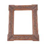 A VICTORIAN CARVED OAK MIRROR