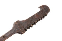 A CARVED WOODEN CLUB, POSSIBLY NATIVE AMERICAN