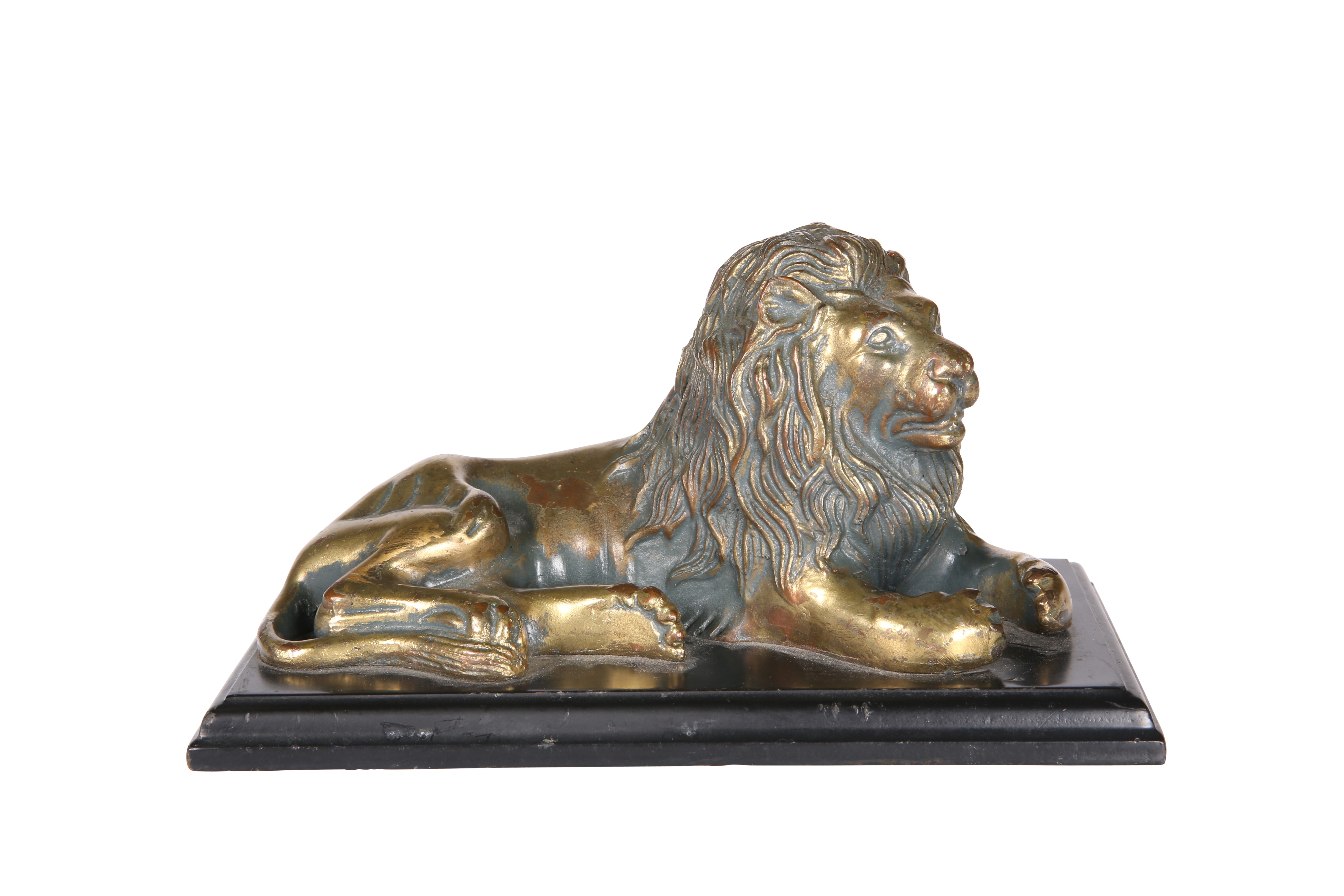 A GILDED BRONZE MODEL OF A RECUMBENT LION