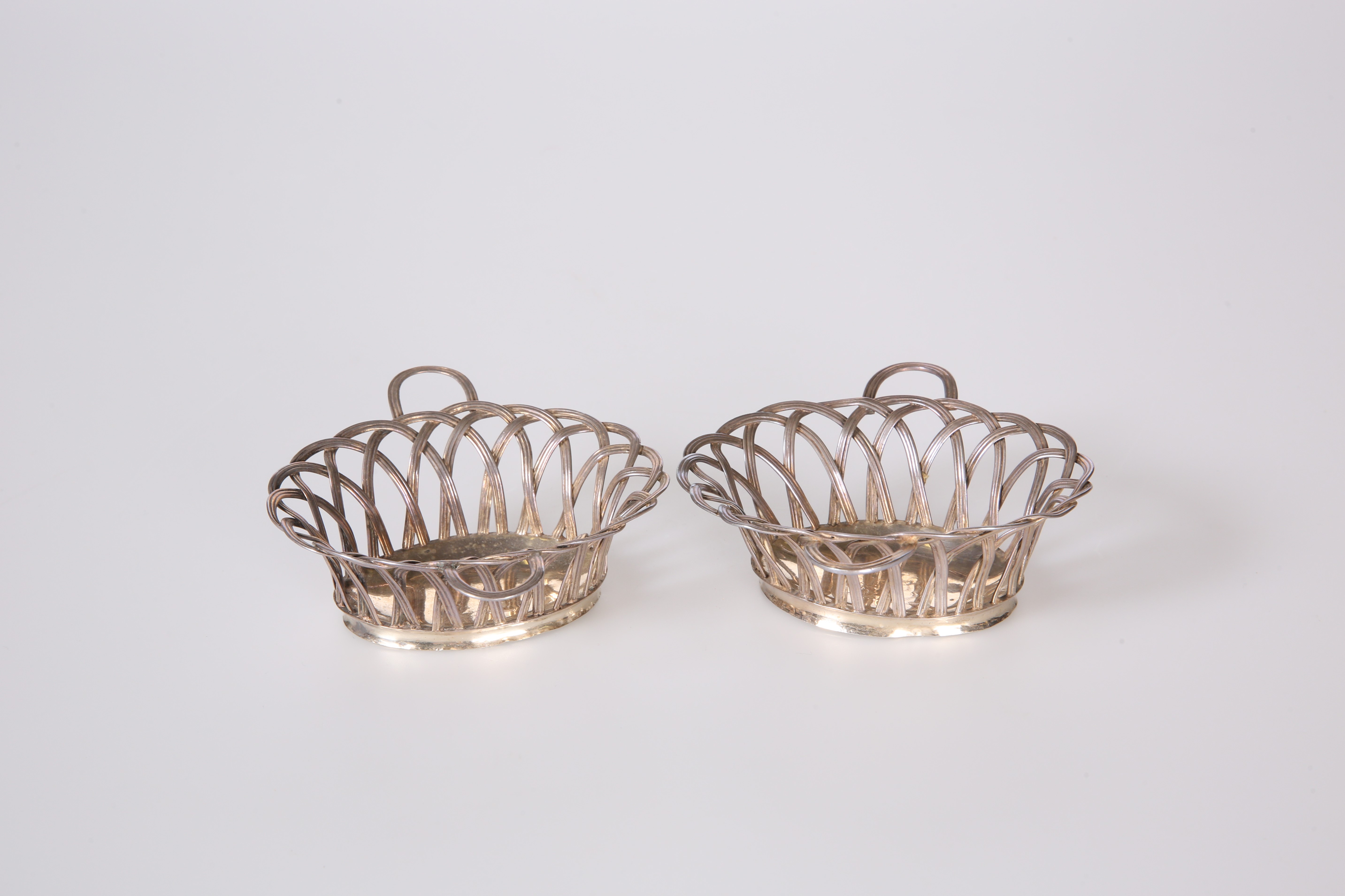 A PAIR OF GEORGE III SILVER SWEETMEAT BASKETS