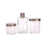 A SET OF THREE GEORGE V SILVER-TOPPED CUT GLASS DRESSING TABLE BOTTLES, HALLMARKED FOR LONDON 1924