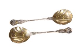 A PAIR OF LATE VICTORIAN SILVER AND SILVER-GILT FRUIT SERVING SPOONS