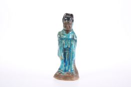 A SMALL MING BLUE GLAZED POTTERY FIGURE OF A GOD