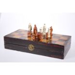 A CHINESE CHEQUERBOARD CASED IVORY CHESS SET, EARLY 20th CENTURY