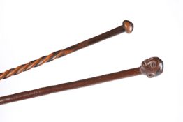 A TRIBAL KNOBKERRIE AND ANOTHER TRIBAL STICK WITH HEAD CARVED HANDLE