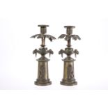 A PAIR OF 19th CENTURY PATINATED METAL CANDLESTICKS IN THE REGENCY TASTE