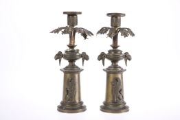 A PAIR OF 19th CENTURY PATINATED METAL CANDLESTICKS IN THE REGENCY TASTE