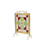 AN EDWARDIAN BRASS, LEADED AND STAINED GLASS FIRESCREEN