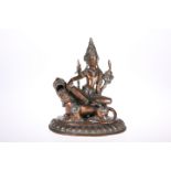 A COPPER AND WHITE METAL FIGURE GROUP OF SHIVA SEATED ON A TIGER, POSSIBLY TIBETAN