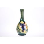 A WALTER MOORCROFT POTTERY BOTTLE SHAPED VASE