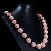 A CARVED CORAL NECKLACE