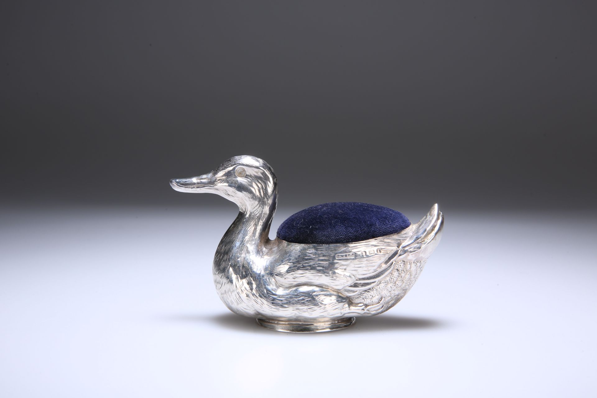 AN EDWARDIAN SILVER NOVELTY PIN CUSHION, IN THE FORM OF A DUCK