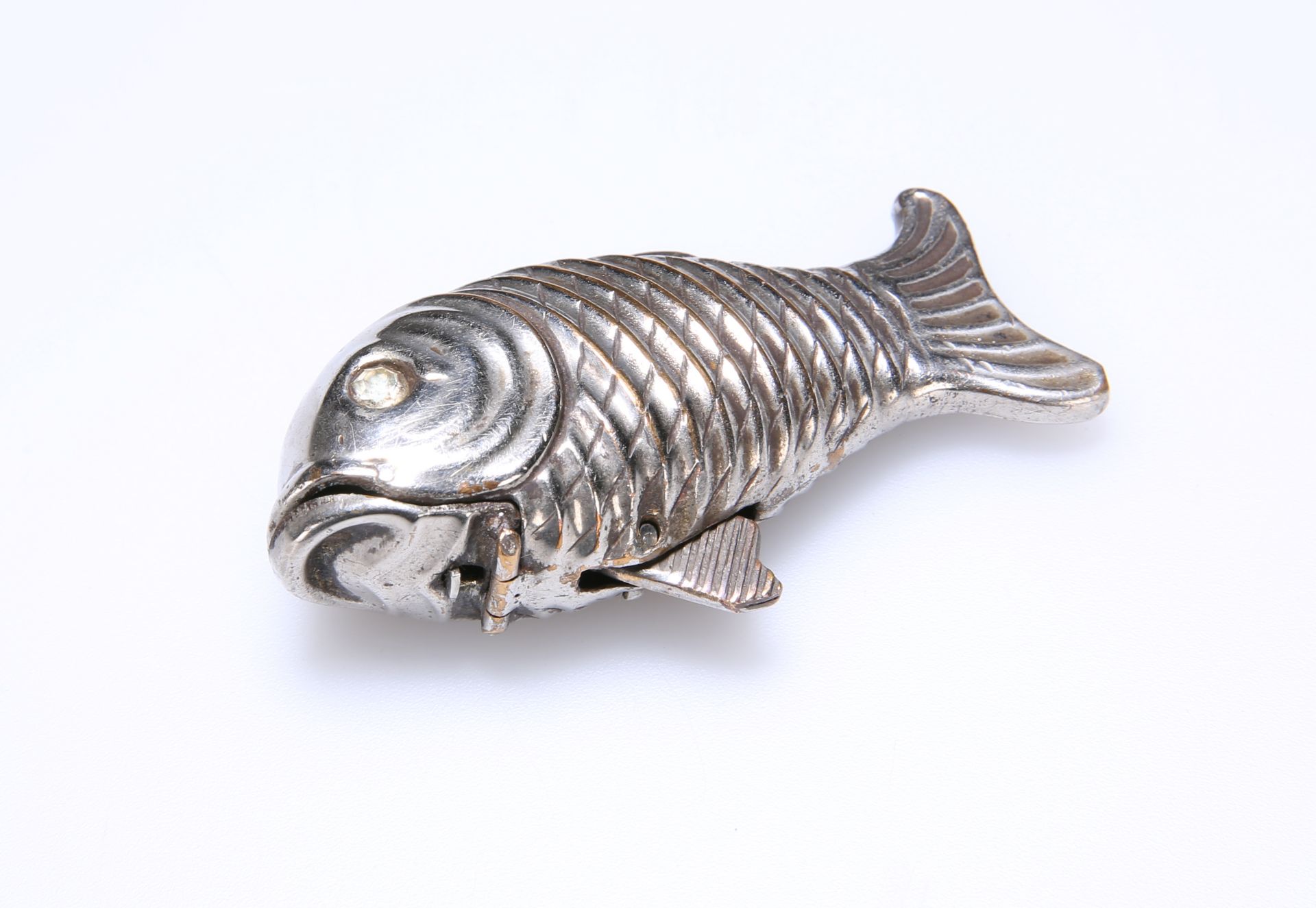 AN UNUSUAL WHITE METAL VESTA CASE, IN THE FORM OF A FISH