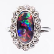 A PLATINUM, BLACK OPAL AND DIAMOND RING