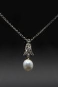 A NATURAL SALTWATER PEARL AND DIAMOND PENDANT