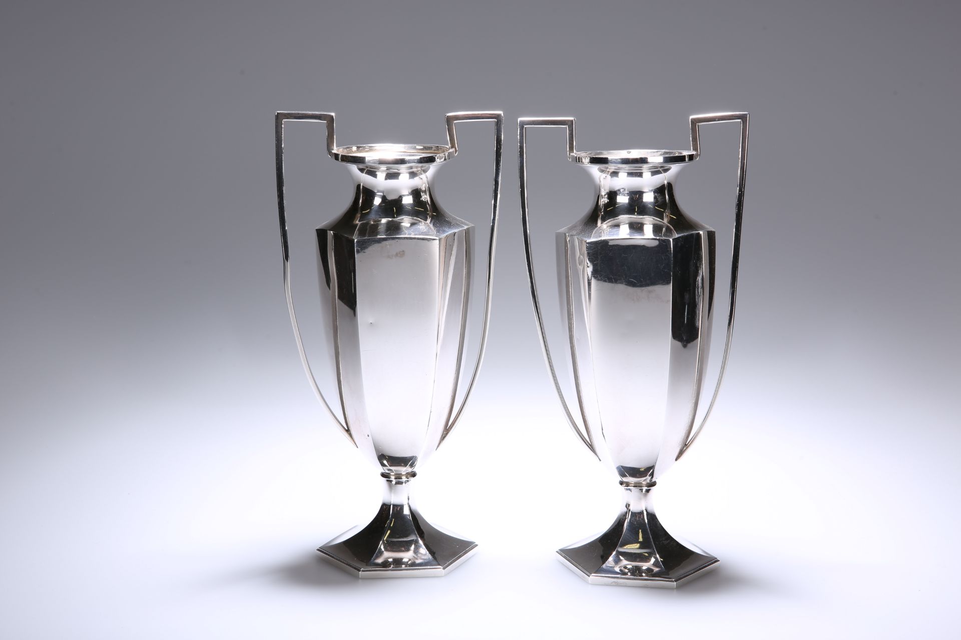 A PAIR OF CHINESE SILVER TWIN-HANDLED VASES, c. 1920