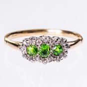 A DEMANTOID GARNET AND DIAMOND RING