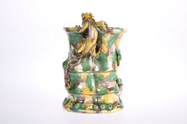 A CHINESE POTTERY VASE IN A SU-SANCAI GLAZE MODELLED WITH A DRAGON