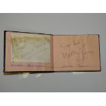 AN AUTOGRAPH BOOK containing a small selection of signatures to include BERNARD BRESSLAW
