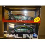 A PAIR OF 1:18 SCALE DIECAST MODEL RACING CARS both ASTON MARTIN DBR9 24H LE MANS RACING CARS, one
