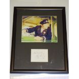 AUTOGRAPH: A FRAMED AND GLAZED MOUNTED PHOTOGRAPH AND SIGNATURE: REG VARNEY (ON THE BUSES)