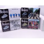 A group of Corgi "The Beatles" diecast London Taxis with Beatles album cover artwork, in collectable