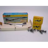 A Corgi Toys 650 diecast Concorde in BOAC blue/gold livery, together with a pair of Dinky fighter