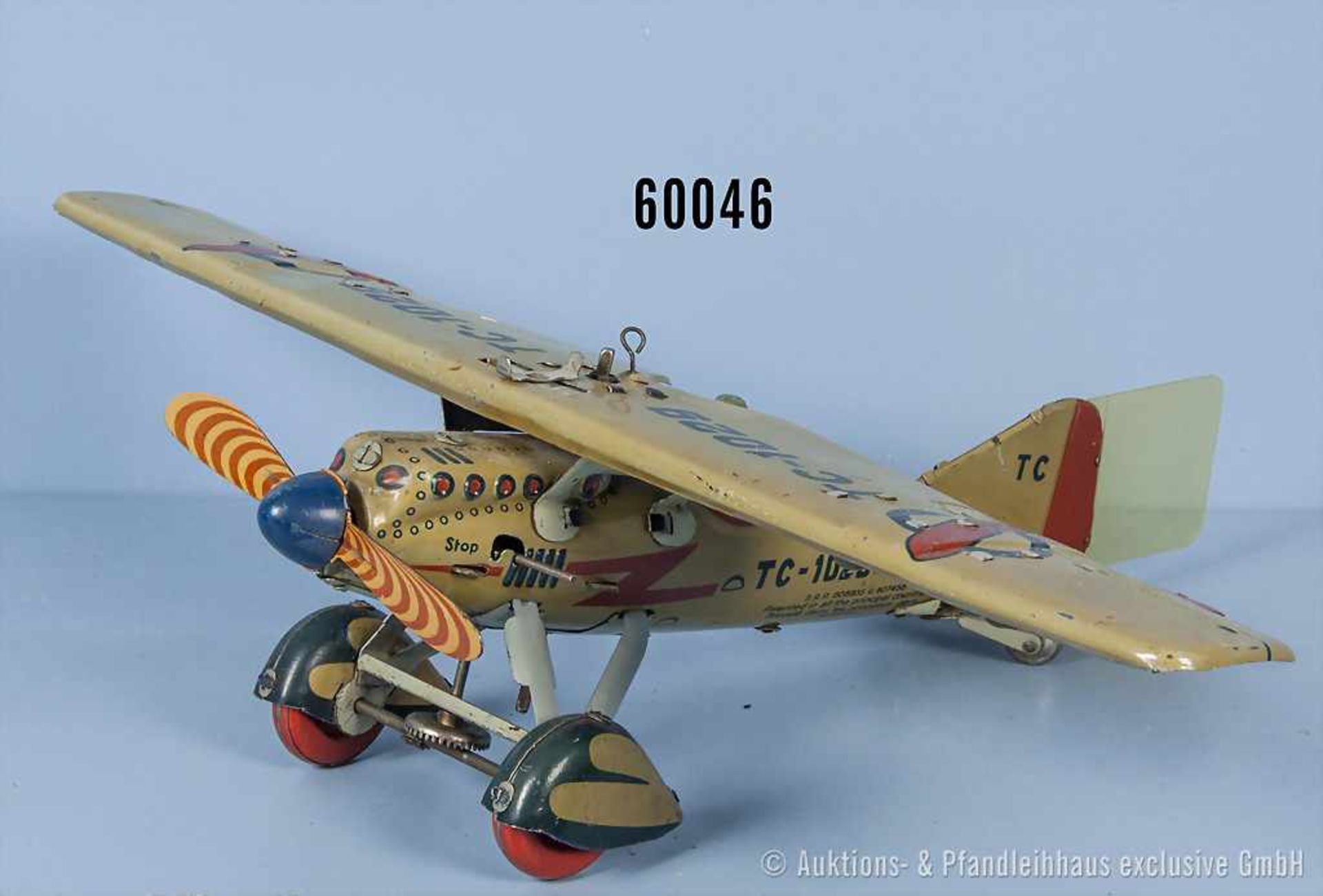 Tipp-Co Bombenflieger TC-1029 mit Pilot, lith. Vollblechausf. mit Uhrwerkantrieb, Propeller, Räder