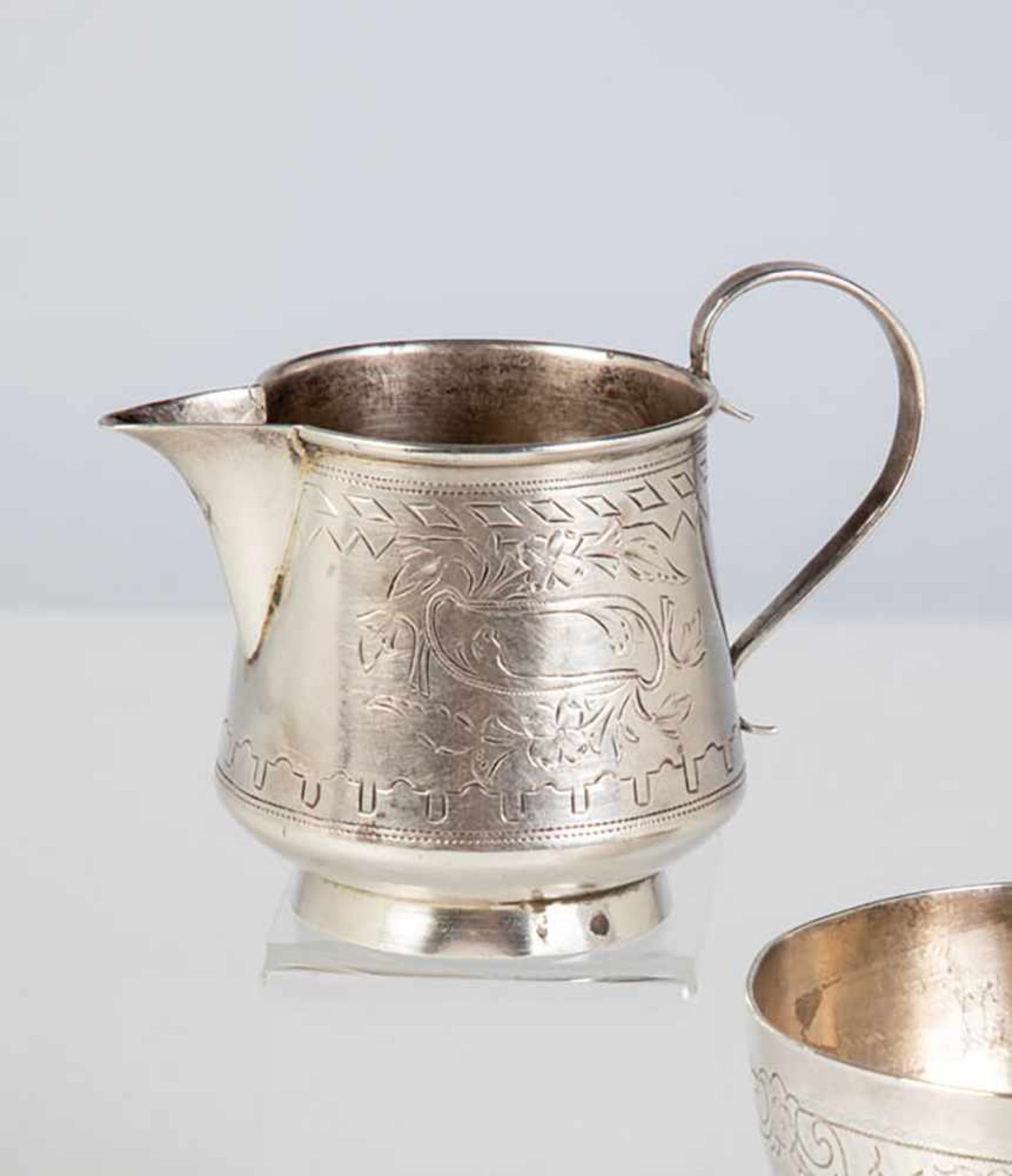 A silver jug. Russia, Moscow, I. Raspopov, 1888. Engraved body. Bottom stamped withhallmark, 84-