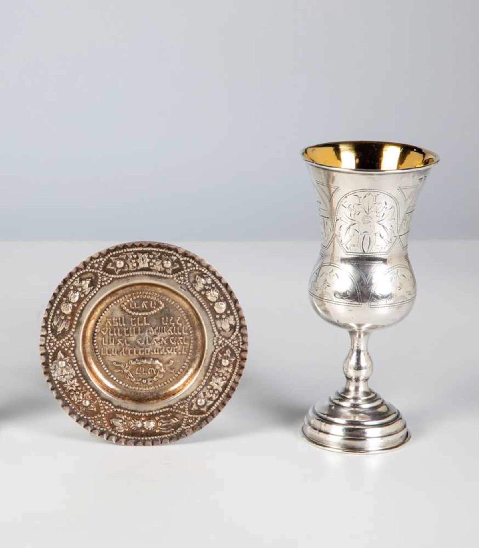 A silver judaica beaker and small plate. Circa 1880. Beaker with engraved decor, stampedwith 84-