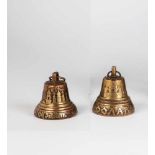 Two small brass and copper bells. Russia, early 20th century. Cast in relief: one withmunicipal coat