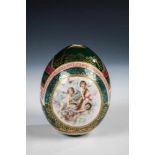 A large porcelain egg. Russia, 20th century. Polychrome printed, gold partial in relief.Losses. 12