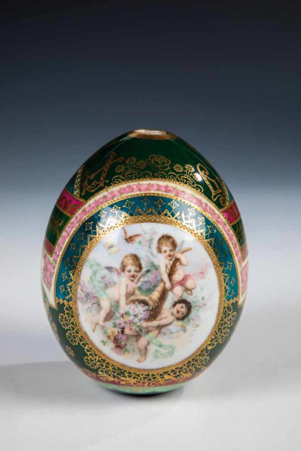 A large porcelain egg. Russia, 20th century. Polychrome printed, gold partial in relief.Losses. 12