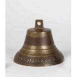 A bronze bell. Russia, early 20th century. Border with cyrillic insription in relief.Vertical crack.