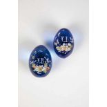 Two blue glass eggs. Russia, 20th century. Decorated with enamel painting. Slightlychipped. 6 - 7 cm