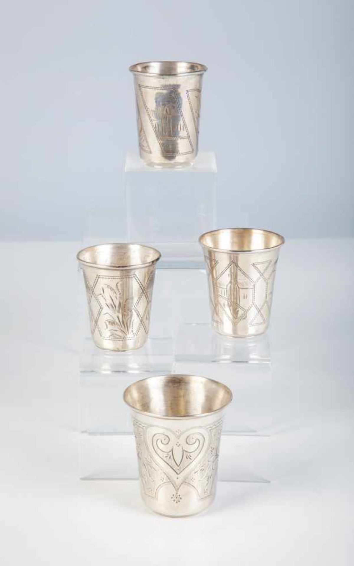 Four silver beakers. Russia, 1868 (one), 1896-1908 (two), 1908-1917 (one). All withengraved decor.