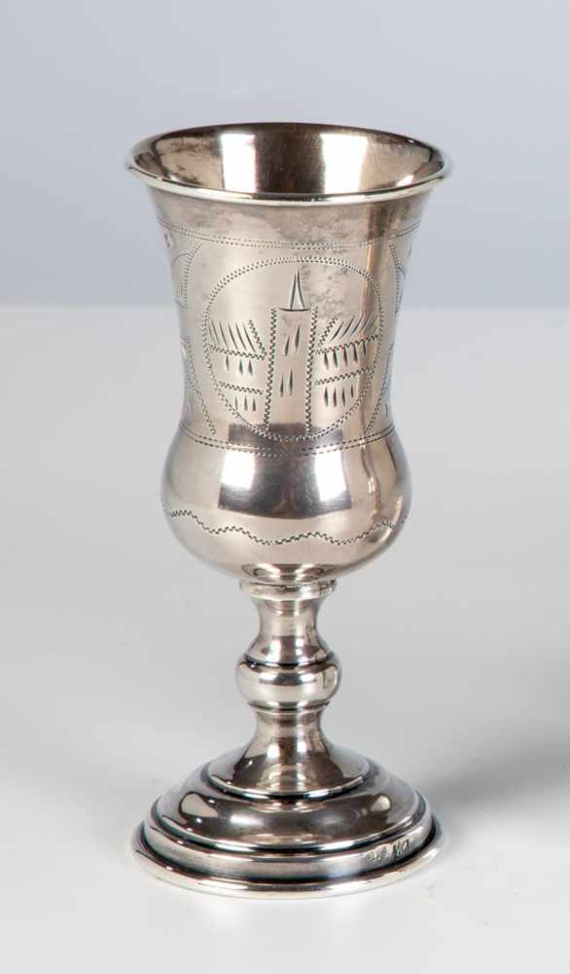 A silver beaker. Kiev, circa 1900. Gilt interior. Engraved houses and flowers. Stampedwith