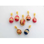Seven silver-gilt and enamel egg-pendants. Modern. Ovoid body decorated with translucidenamel. Three
