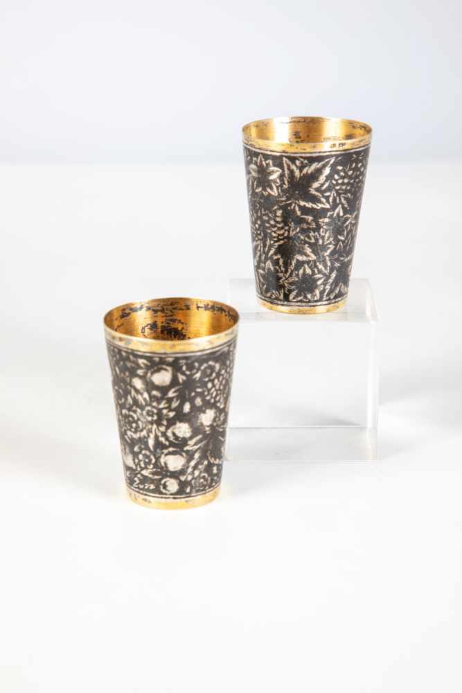 Two silver-gilt and niello vodka beaker. Russia, Tula, late 19th century. Body withnielloed