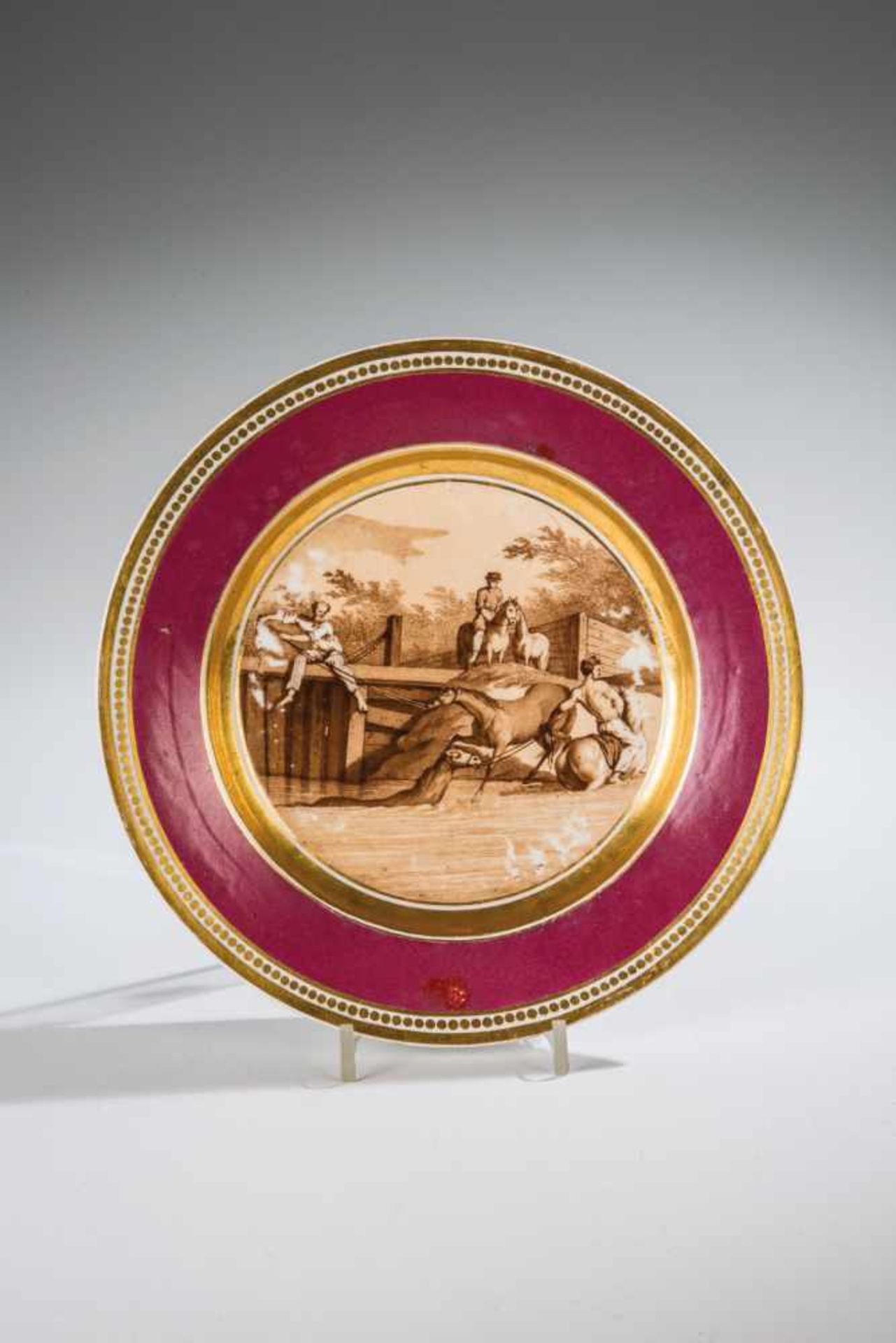 A porcelain plate with horses. Russia, circa 1850. Polychrome overglaze painting. Roundgilded stand.