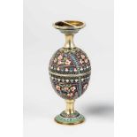 A silver-gilt and cloisonné enamel double egg cup. Early 20th century. Ovoid body withpolychrome