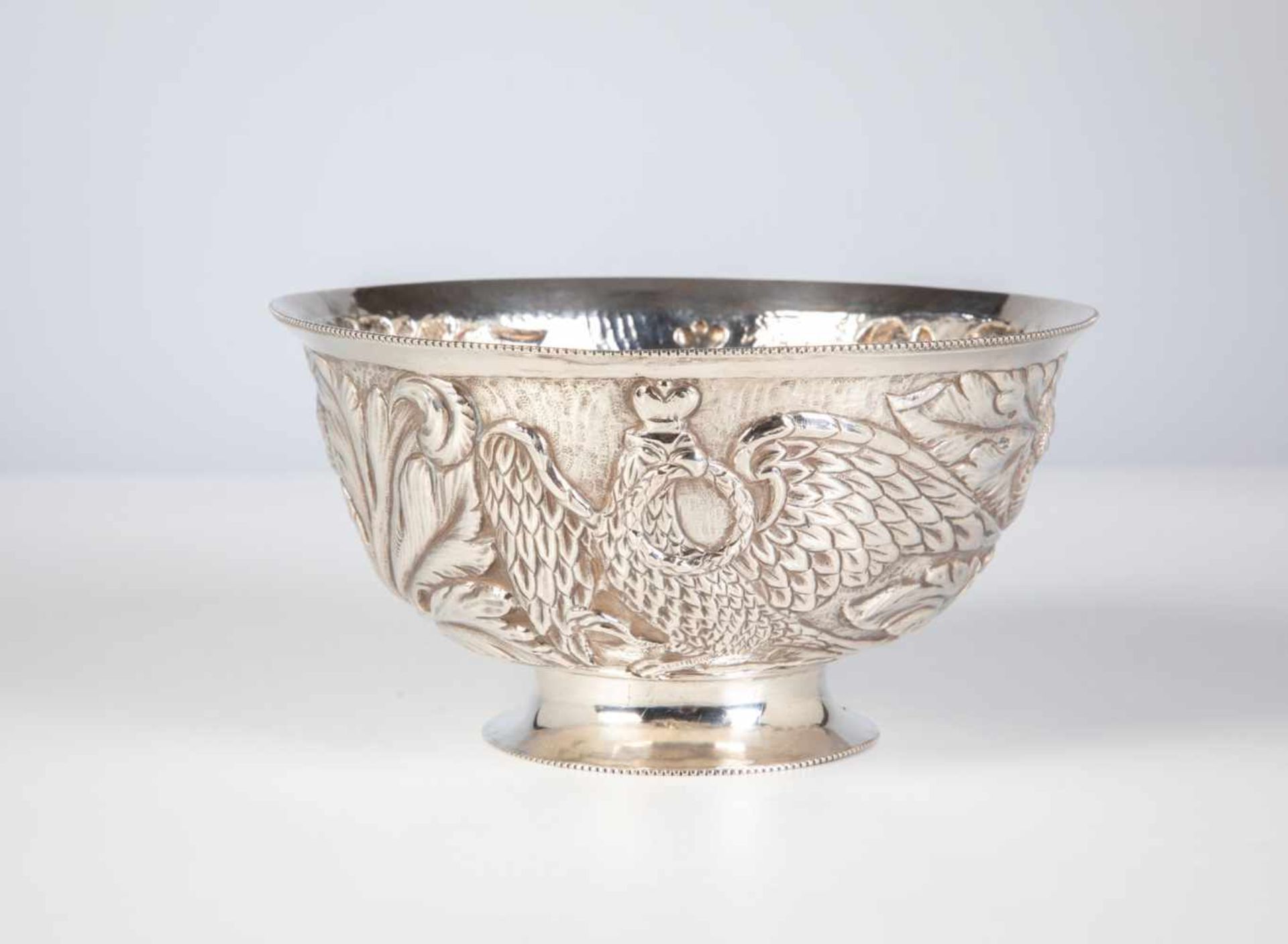 A silver bowl. Russia, Moscow, 1788. Round stand. Round body with embossed decor: twocrowned