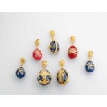 Seven silver-gilt and enamel egg-pendants. Modern. Ovoid body decorated with translucidenamel. Two