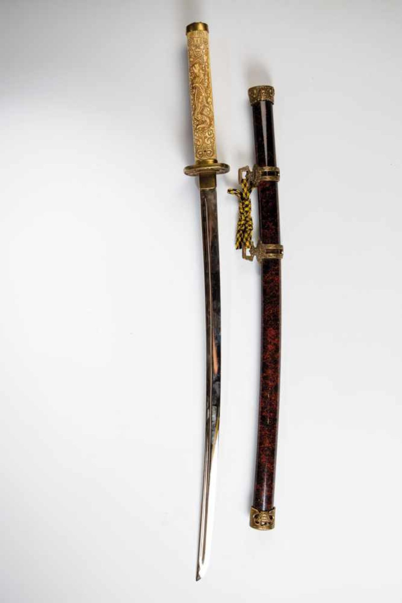 Decorative sword. China, 20./21. century. Handle decorated with floral and dragon carvingsand